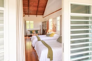 A room with two beds, a wooden ceiling, and a large window with shutters. - New Mountain Escape Panoramic San Juan Views (Aguas Buenas)