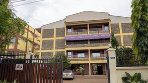 A two-story hotel with a gated entrance, balconies, and a sign indicating the name "Whitley Hotel." - Whirlsprings Hotel Kisumu (Kisumu)