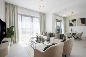 Ein modernes Wohnzimmer mit Sofa, Couchtisch und Essbereich.
