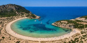 An aerial view of a coastal beach with clear waters, boats, and a hilly landscape. - Ionian Waves Villa - Marathopoli Stylish Escape (Trifylia)