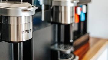 Une machine à café au fini métallique, sur laquelle on peut voir le nom de la marque « KEUR ».