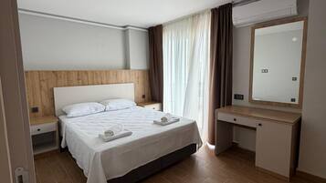 Apartment, Balcony, Sea View | Desk, laptop workspace, blackout drapes, iron/ironing board
