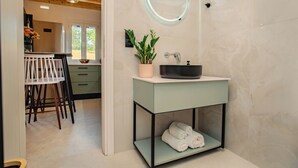 A bathroom with a sink, mirror, and towel shelf. - 25 meters from the beach (Lefkimmi)