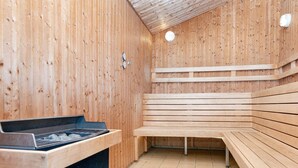 A sauna with wooden benches and a sauna table. - 6 Person Holiday Park Home in Hemmet (Hemmet)