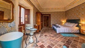 A room with a bed, a sink, and a mirror.