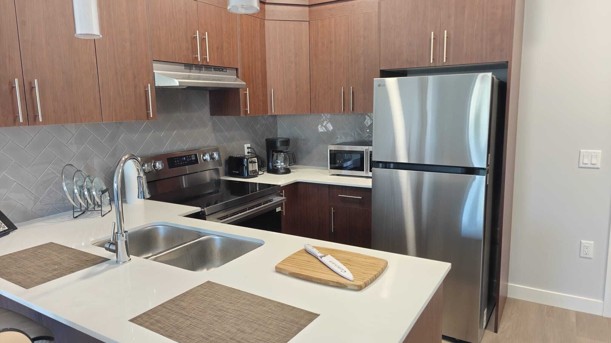 Full-sized fridge, stovetop, coffee/tea maker, cookware/dishes/utensils