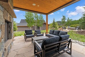 An outdoor patio with stone flooring, a wooden pergola, and outdoor furniture. - Pet-Friendly with Mountain Views - Minutes from Maryland Creek Dog Park (Silverthorne)