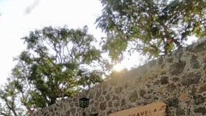 A stone building with a wooden door and a sign reading 'CASA CHAVELA'.