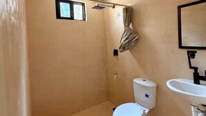 A small bathroom with a toilet, a sink, and a shower. - Casa Cedro | Private Studio 10, North Mérida (Mérida)