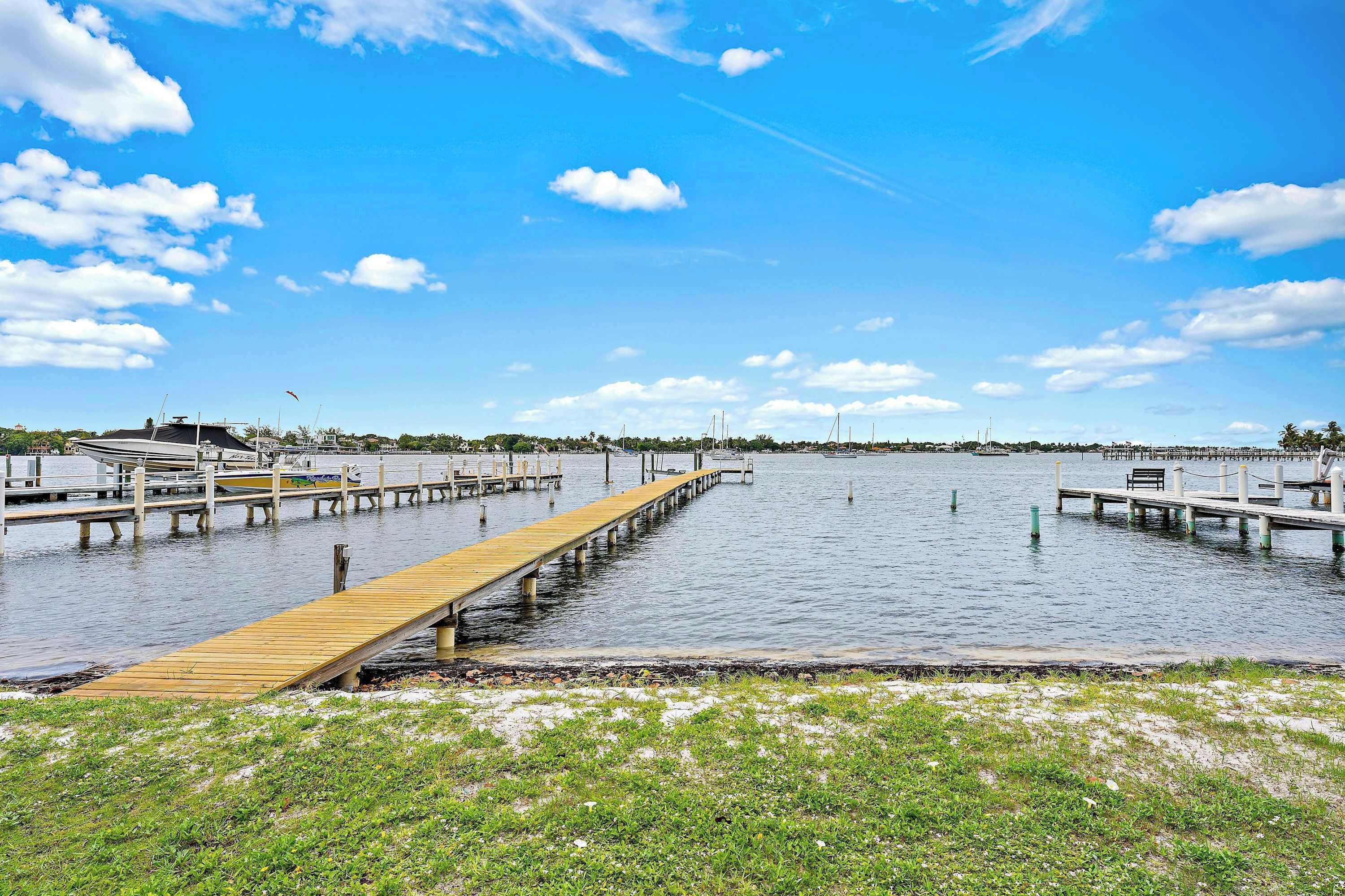 A waterfront dock with wooden walkways and boats.