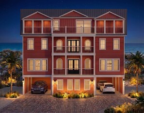 A multi-story house with a balcony, a garage, and a driveway. - Brand New 10BR Oceanfront Home (Georgetown County)