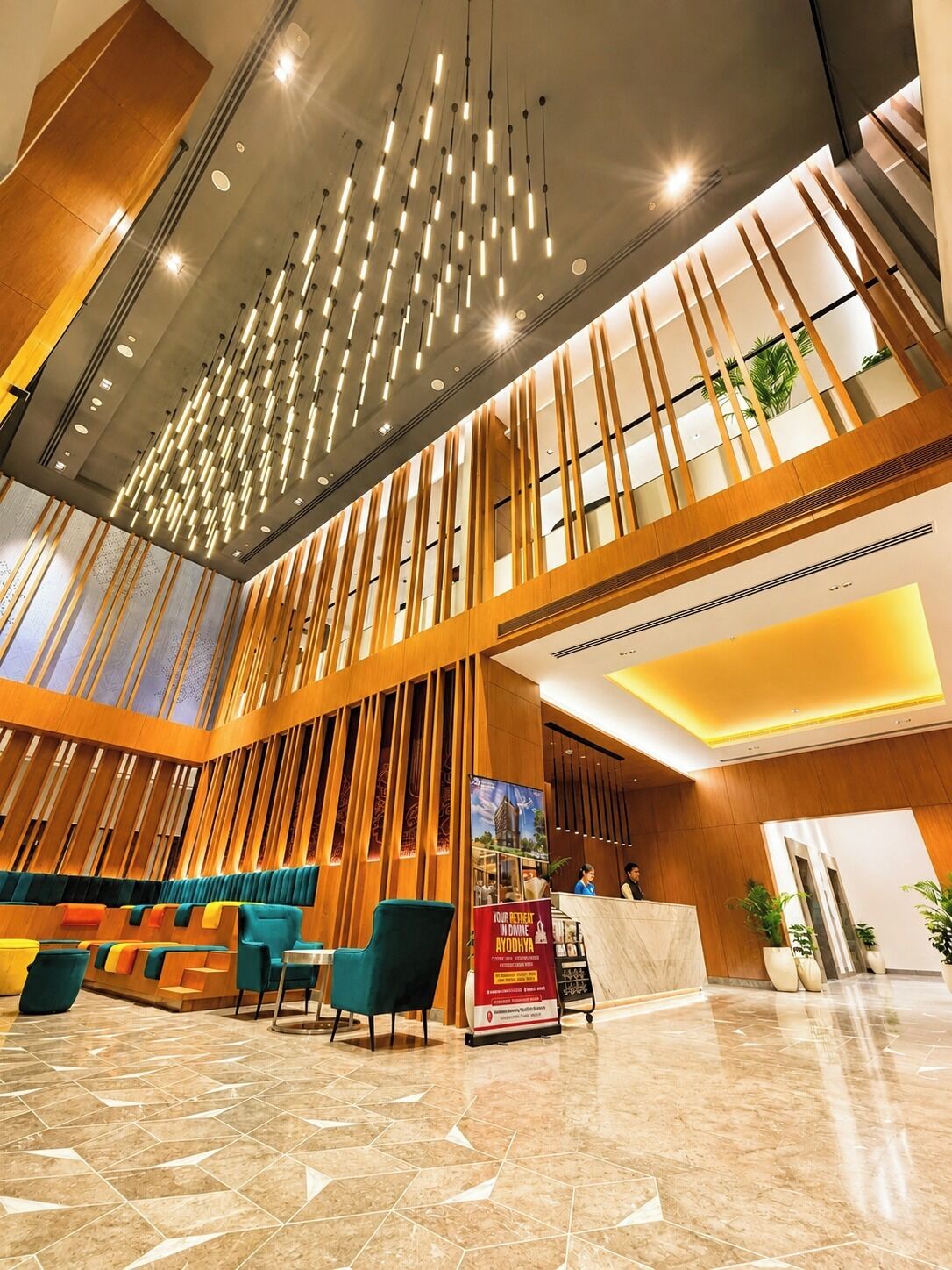 A hotel lobby with a reception desk, seating area, and a modern ceiling design.