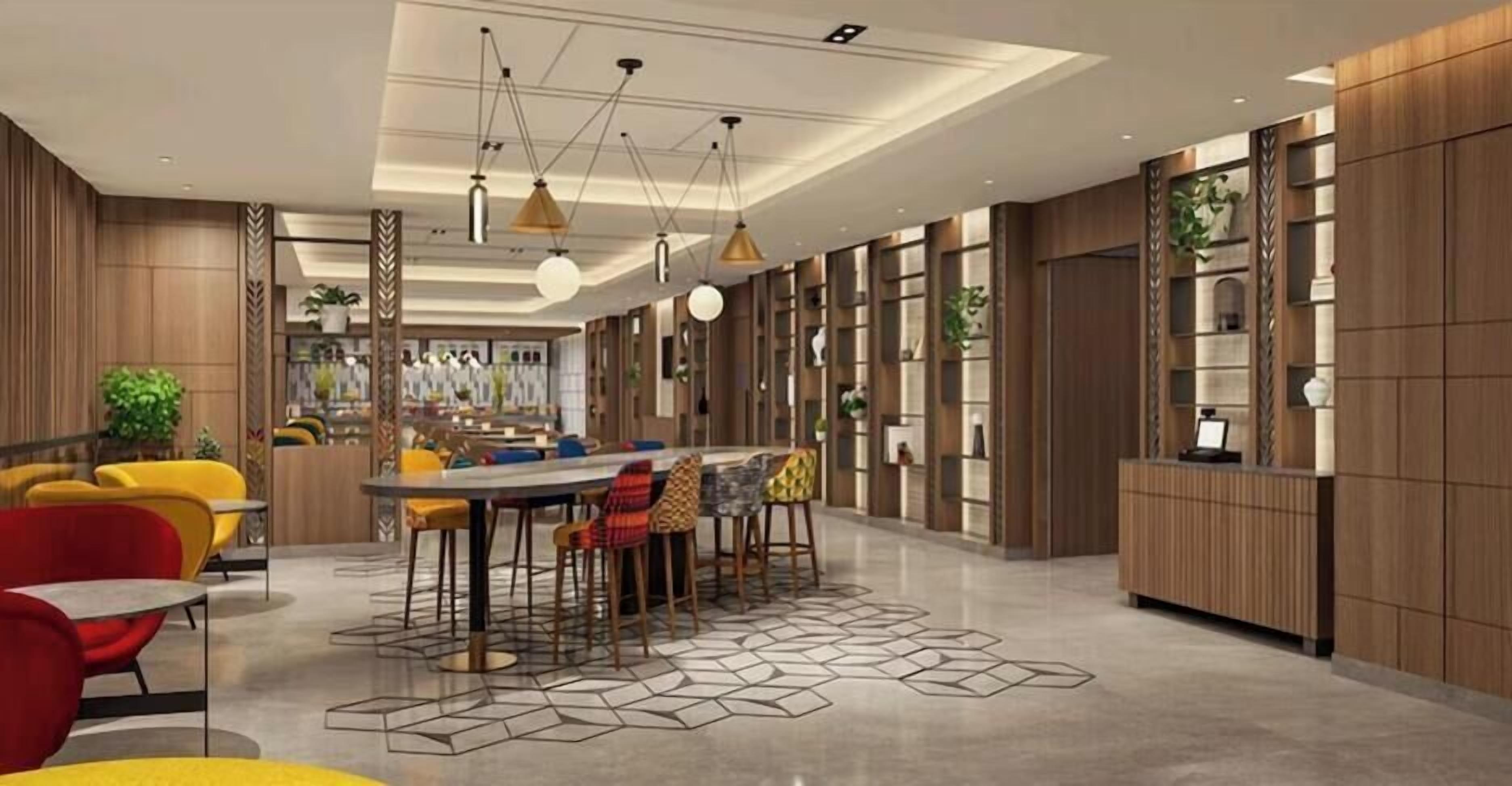 A modern interior with a central dining area, multiple seating options, and built-in shelving.