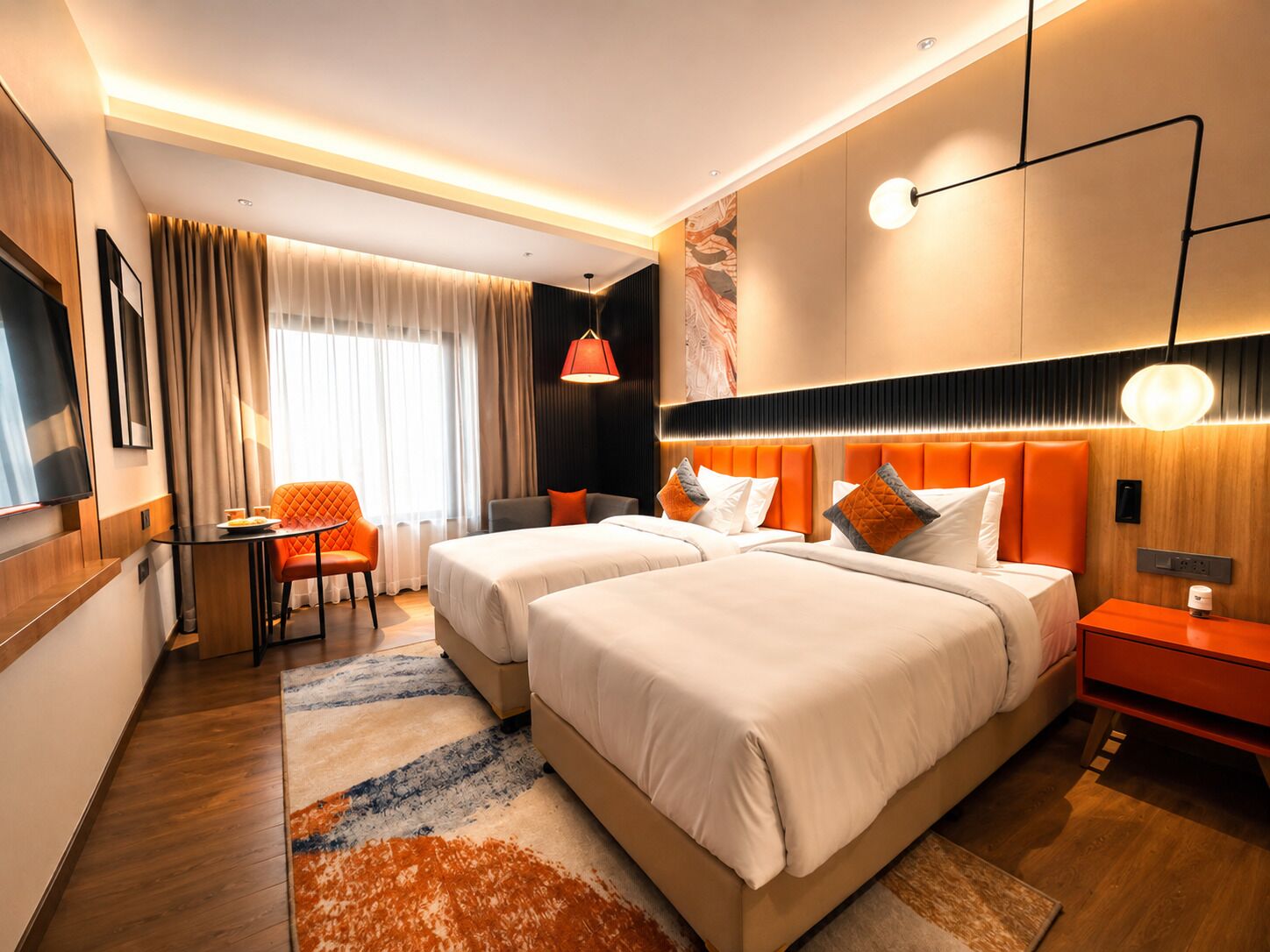 A hotel room with two beds, a TV, a desk with a chair, and a large window with curtains.