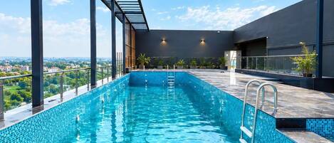 A rooftop infinity pool with a clear view of the city skyline.