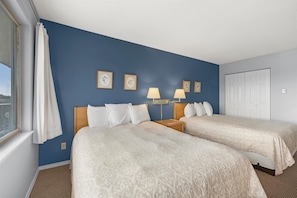 The bedroom houses two queen beds - Family Suite for 6 with Kitchen and Fireplace - Pool, Hot Tub, and Game Room Access! (Ocean Shores)