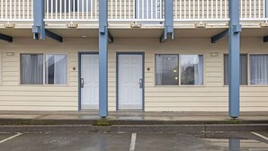 A building with a row of doors, windows, and a balcony.