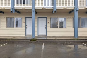 A building with a row of doors, windows, and a balcony.
