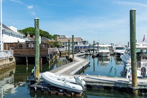 A marina with boats docked, wooden walkways, and a clear sky. - Charming 3-bedroom apartment with AC in East Greenwich (East Greenwich)
