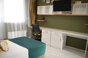 A hotel room with a bed, desk, chair, television, and a window with curtains. - DORA BEYTEPE HOTEL (Ankara)