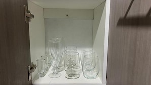 A storage cabinet with multiple clear glassware items.