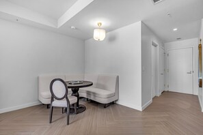 Een moderne kamer met een ronde tafel, een bank en een plafondlamp.