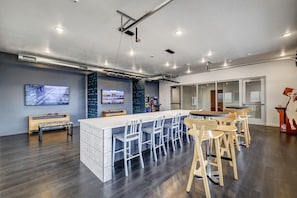 A modern kitchen with a central island, bar stools, and a seating area. - New 1bd Apartment w/Amenities Access (Draper)