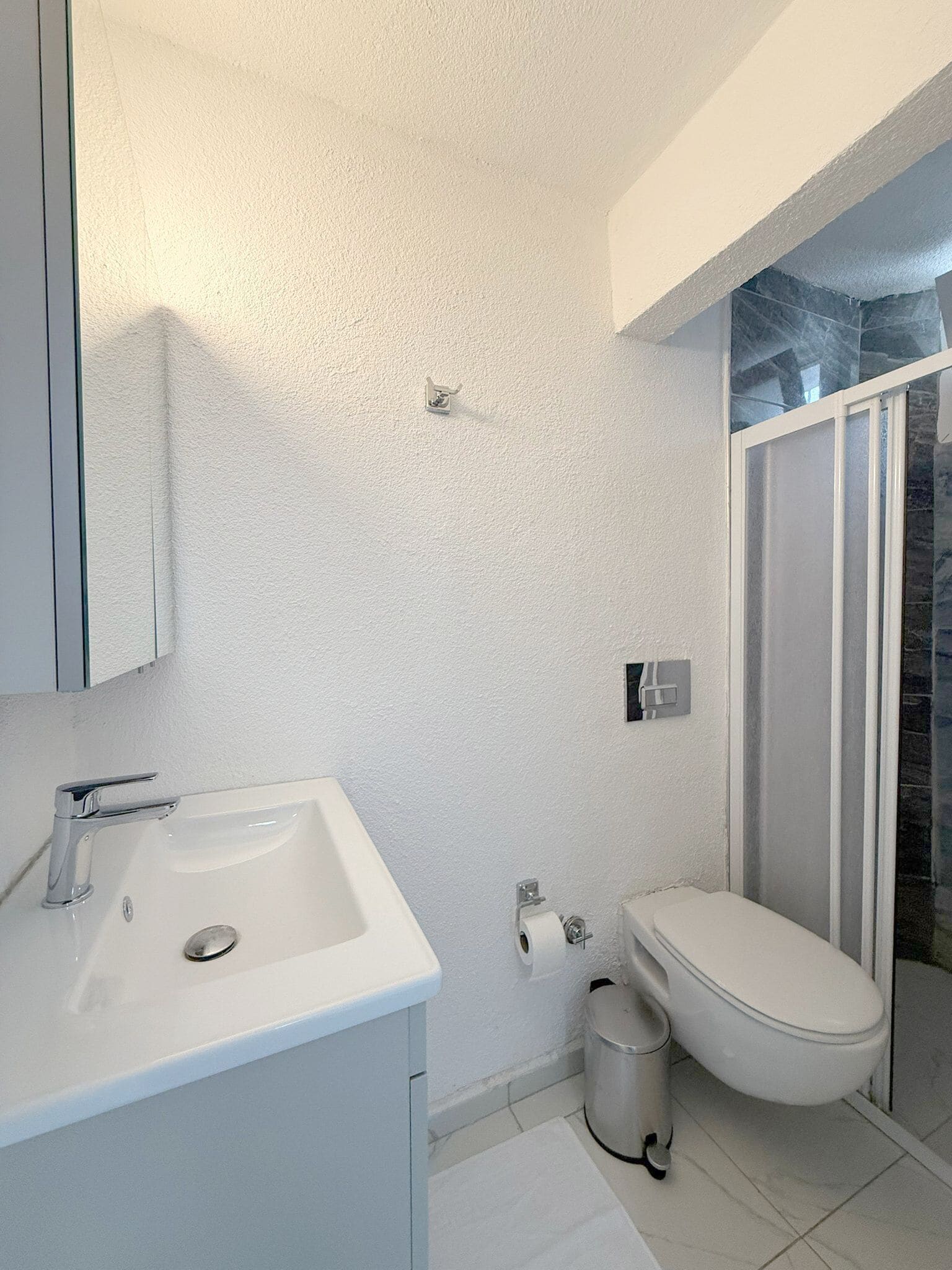 Shower, hair dryer, slippers, towels
