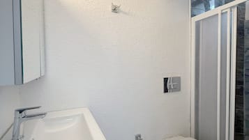 Shower, hair dryer, slippers, towels