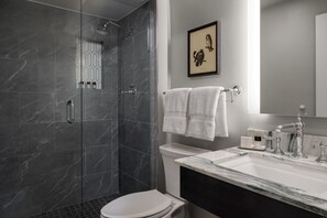 A modern bathroom with a shower, toilet, and sink. - Elegant 2BR with Fireplace & Kitchen | Spa & Golf (Manchester)