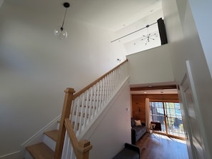 A staircase with wooden railings and a clear view of the upper floor.