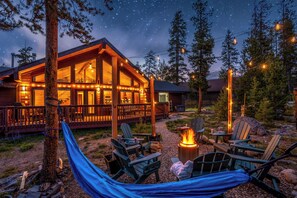 Een lodge met terras, buitenzitplaatsen en een vuurkuil.