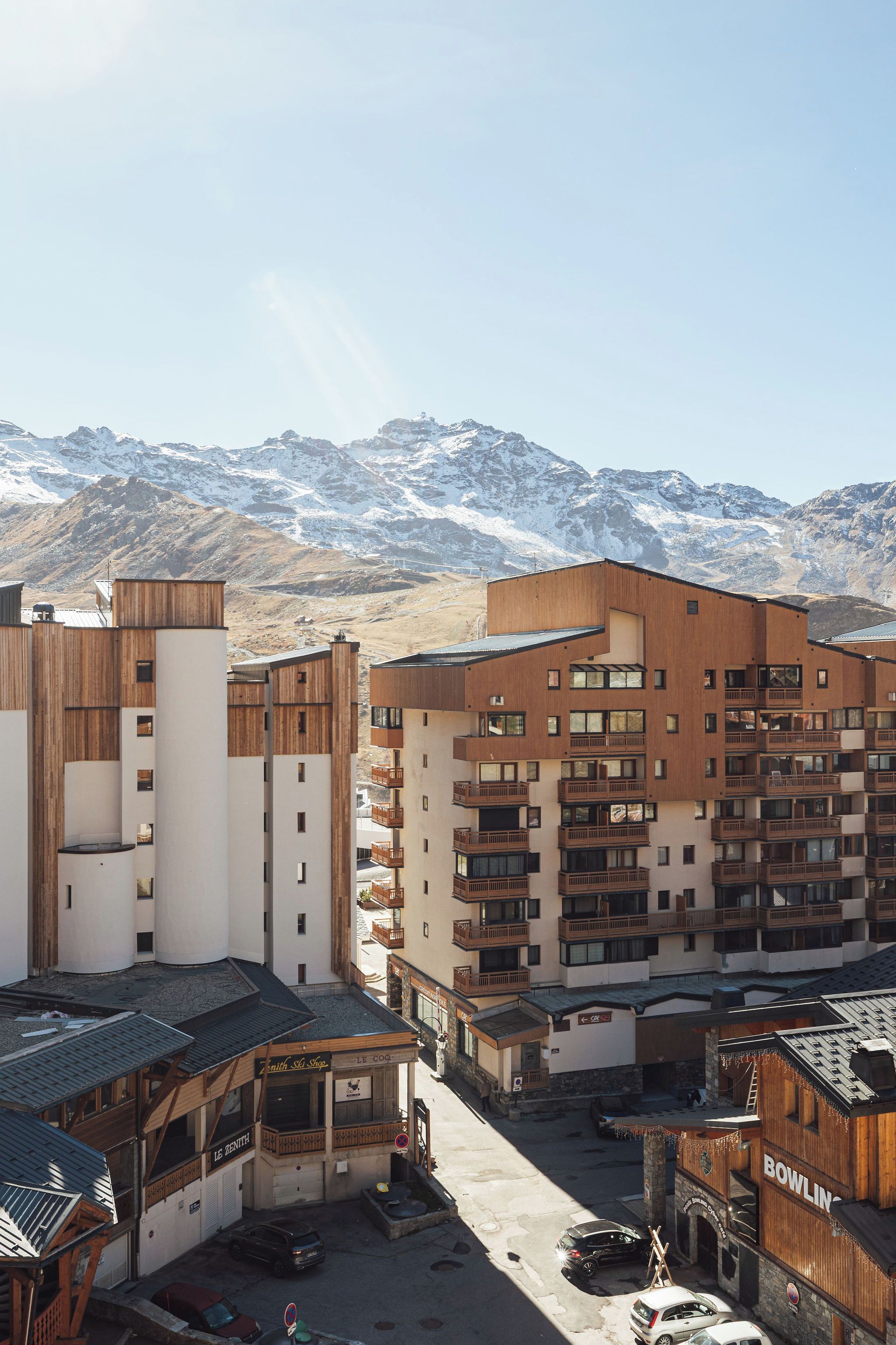 A modern building complex with multiple balconies and a ski shop.