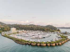 A marina with numerous boats docked, surrounded by a forested hillside. - Come Stay at This Beautiful Studio for Stunning Views of the Pacific Coastline! (Telire)