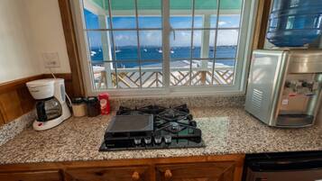 Coffee/tea maker, stovetop, cookware/dishes/utensils, dining tables