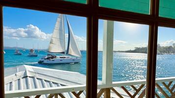 A view of a marina with sailboats and yachts docked.