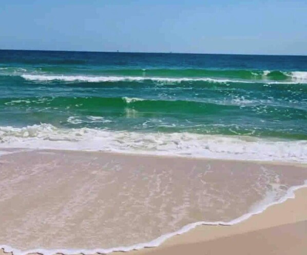 A beach with waves and clear skies. - Spacious Gulf Shores Beach House With Resort-style Amenities (Gulf Shores)