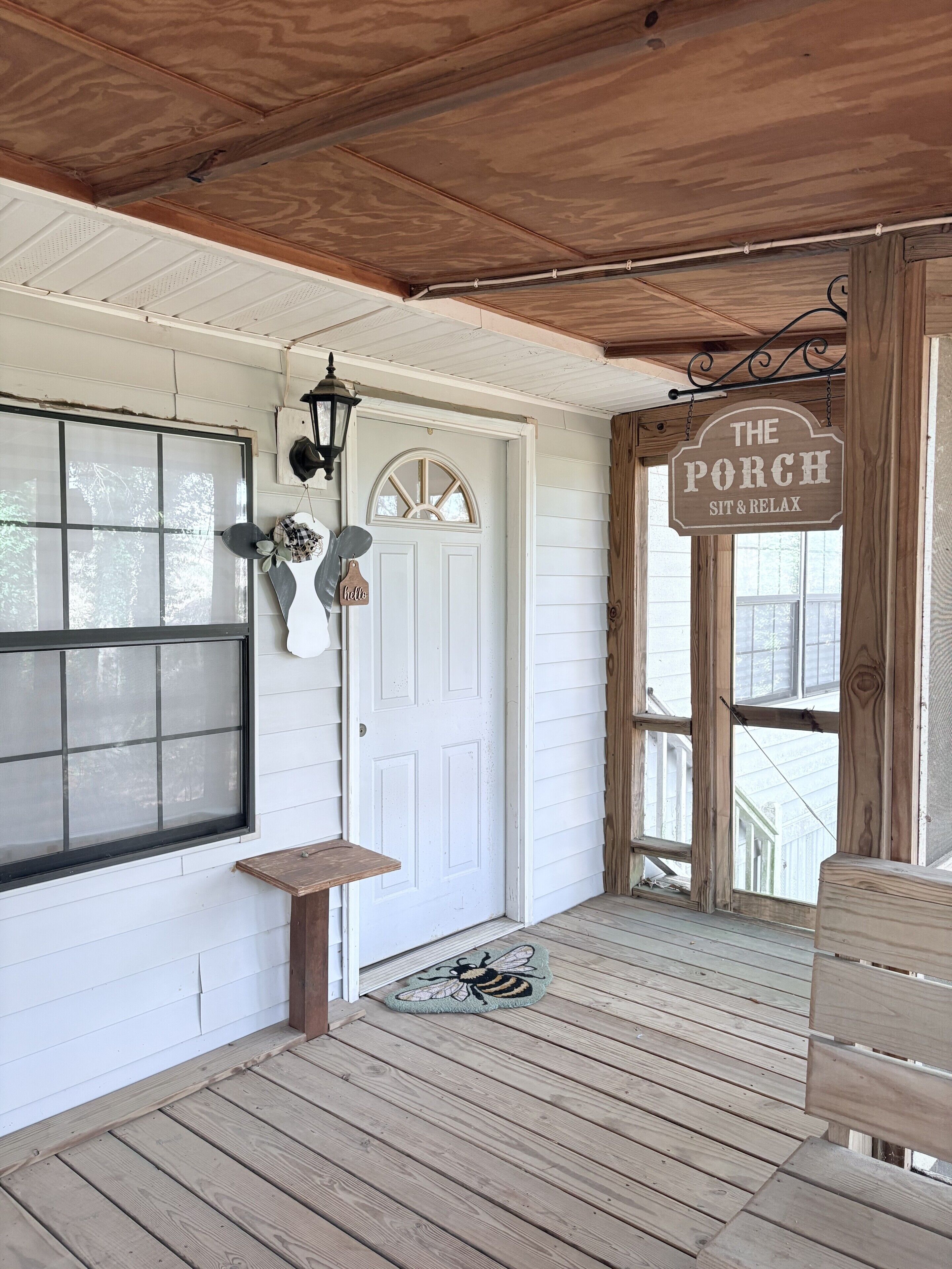Charming screened porch with swing and cozy farmhouse touches