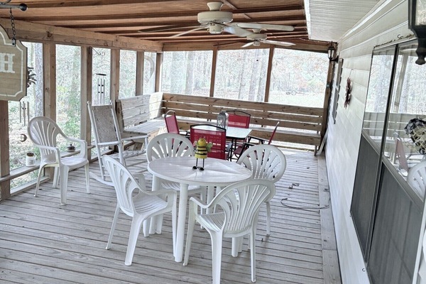 Spacious covered porch with fans, outdoor dining and woodland views