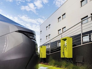 Un edificio moderno con un'auto parcheggiata davanti.