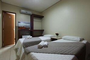A hotel room with two beds, a TV, a mirror, and an air conditioning unit. - Standard Twin Base | Free Parking | Walk to Mercado Municipal & Waterfront Quay (Altamira)