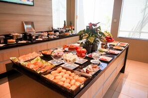 A buffet with various food items and a potted plant. - Quiet, Upscale Room w/ Outdoor Pool Access | Free Breakfast Buffet & Parking (N/A)