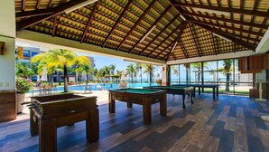 An indoor recreational area with a pool table, pool, and a view of the ocean. - Wai Wai #a204 Comfort Beachfront By Carpediem (Caucaia)