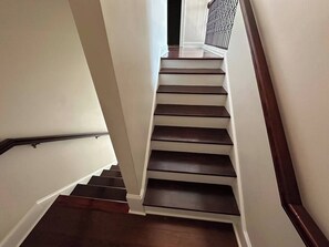 Eine Treppe mit Holzbodenstufen und weißen Wänden.