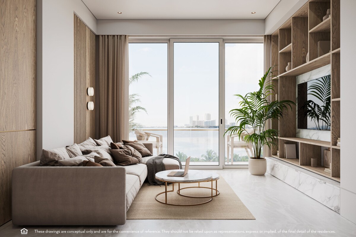 A modern living room with a sofa, coffee table, and a large window with a city view.