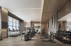A modern gym with treadmills, weight machines, and free weights. - Vida Hotel & Residences (Miami)