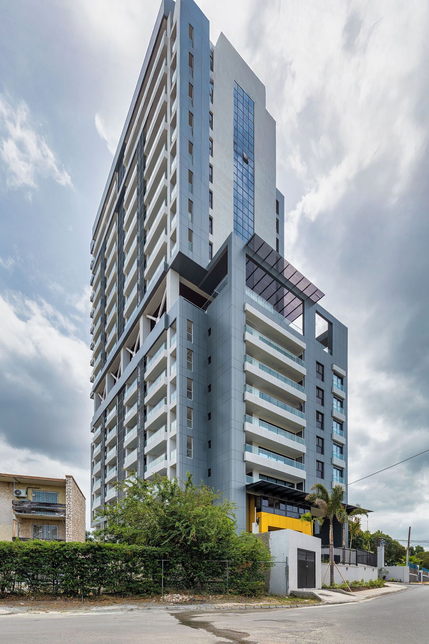 A modern high-rise building with multiple balconies and a prominent glass facade.