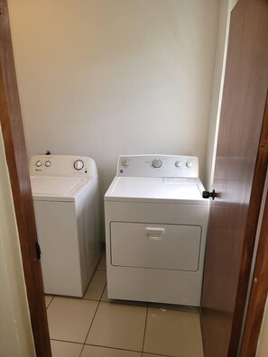 A laundry room with two white washing machines and a dryer. - The Villa in Miradero (Mayaguez)