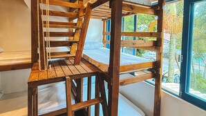 A multi-level wooden staircase connecting different floors of a room with a window providing a view of the outside. - Sea Wolf Surf Hostel - Campeche (Florianópolis)