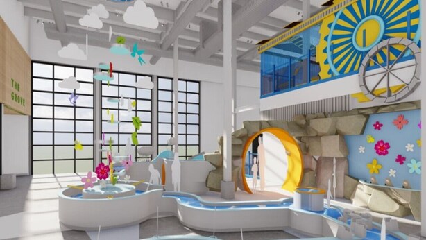 A modern indoor space with large windows, a central water feature, and a distinctive yellow and blue wall decoration.